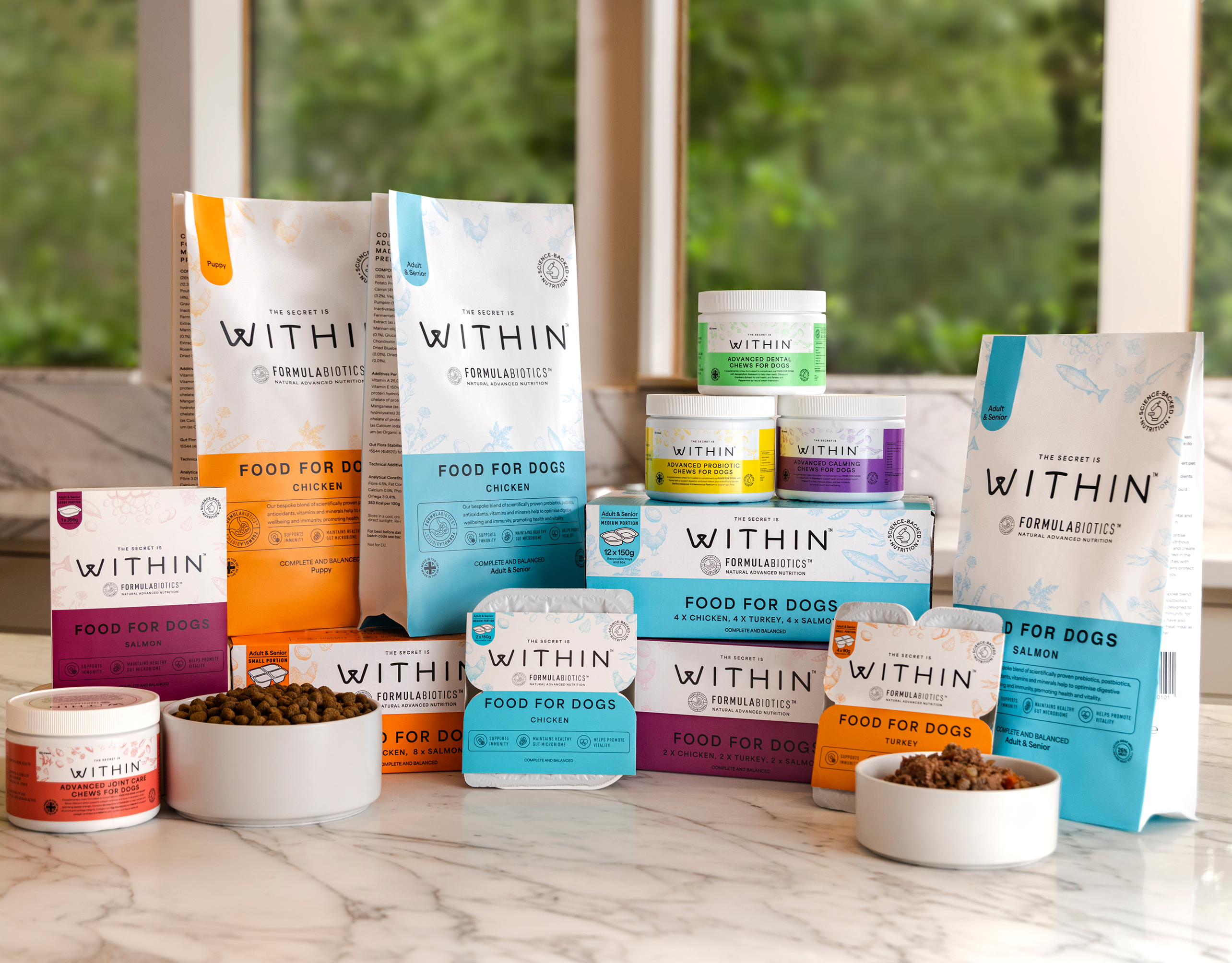 Studio shot showcasing the complete WITHIN range of dry dog food, wet dog food and supplements for dogs.